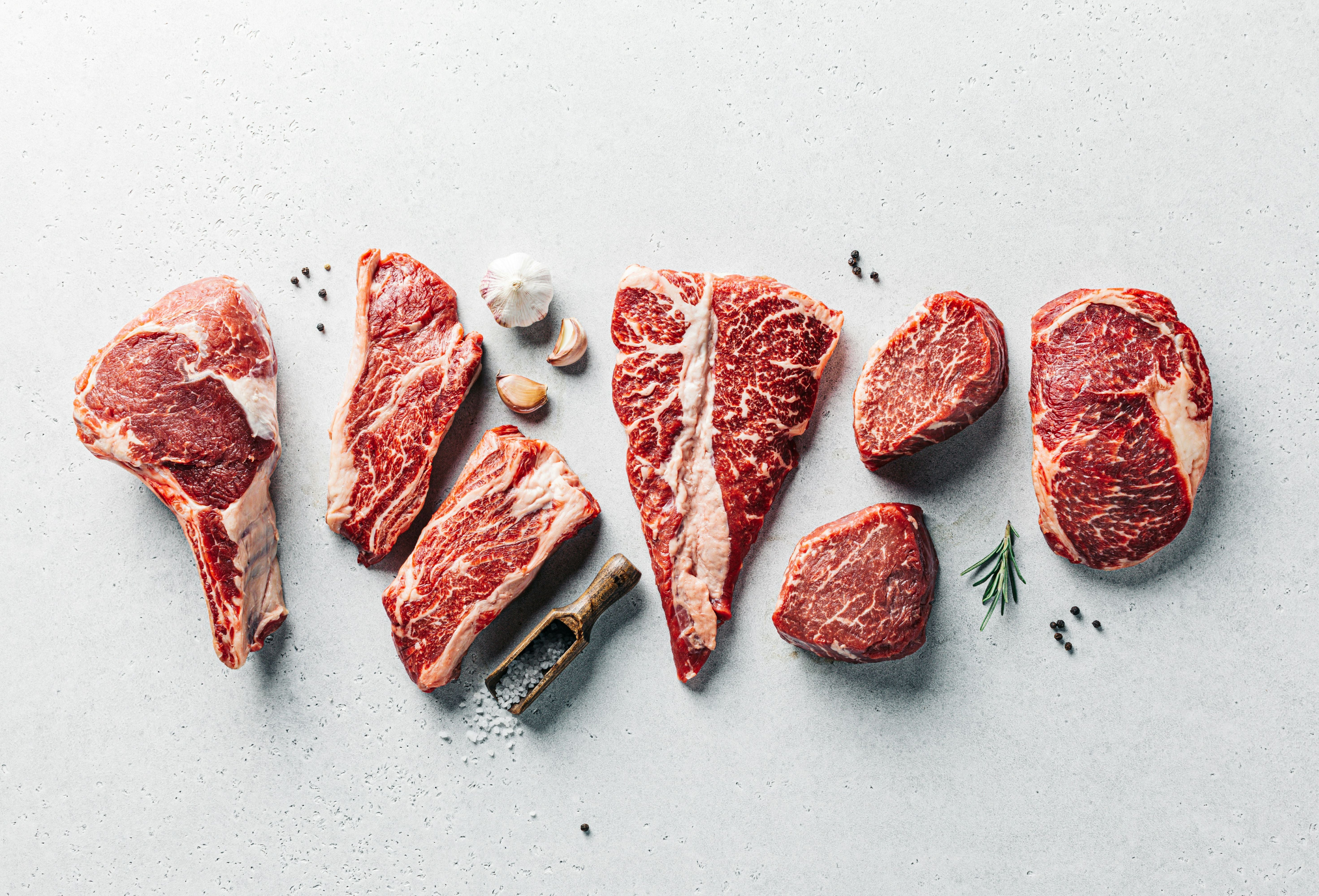 Raw Meats on a Table Photo by Sergey Kotenev on Unsplash